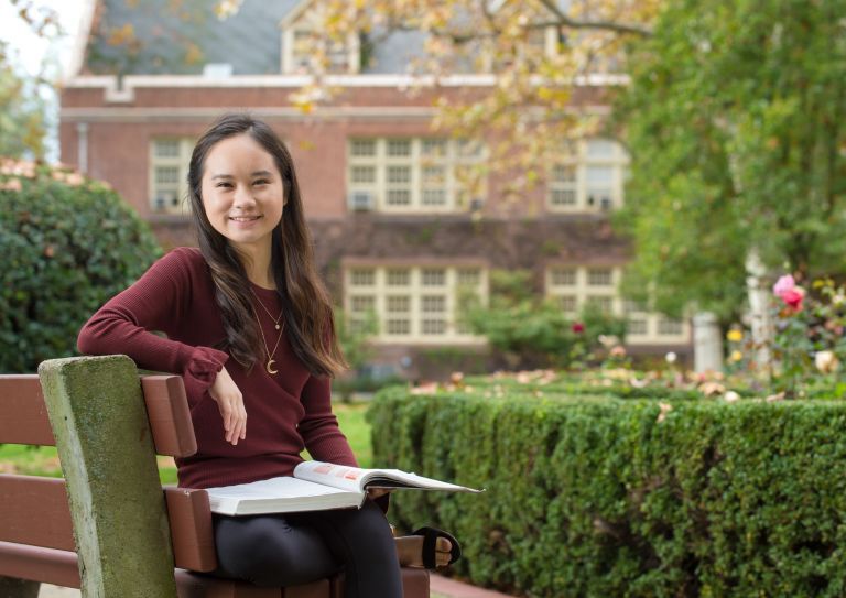 Language student sitting on bench