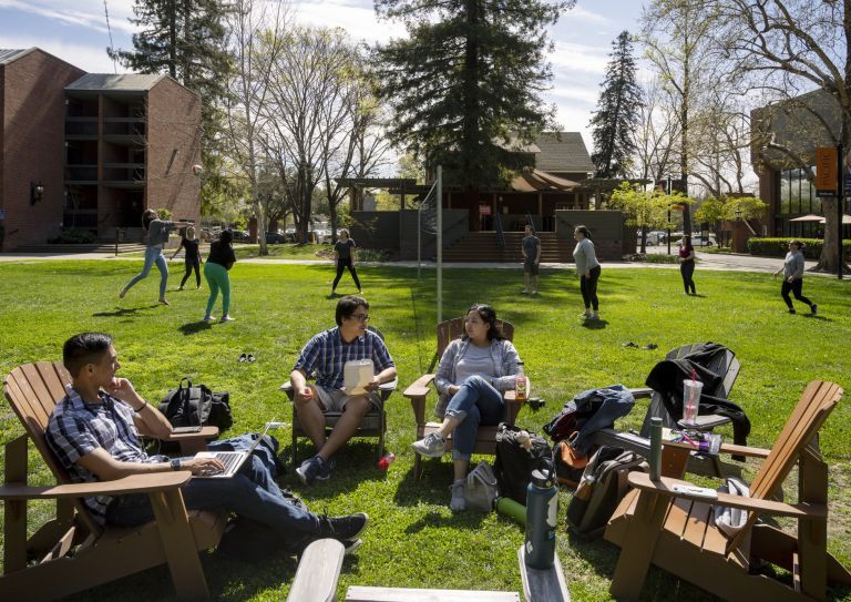 students in the quad with volleyball