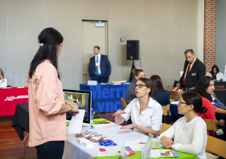 student interacts with employers at career fair