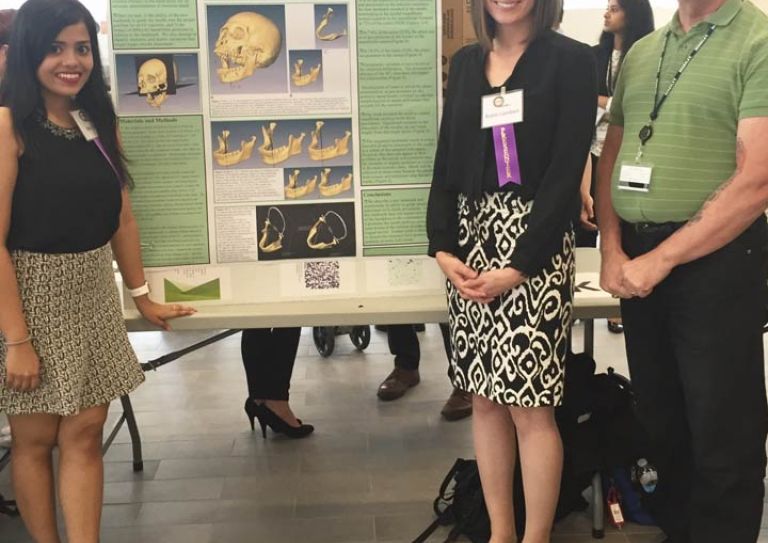 Students Robin Lambert and Riddhima Suri, members of the DDS Class of 2017, along with their faculty advisor Dr. Gary D. Richards, pose with the poster for their project, "A New Insertion Landmark and Modification of the 'Standard Technique' for Inferior Alveolar Nerve Block Injections".