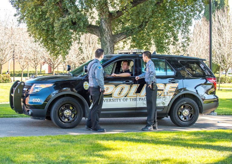 public safety employees gather by a vehicle