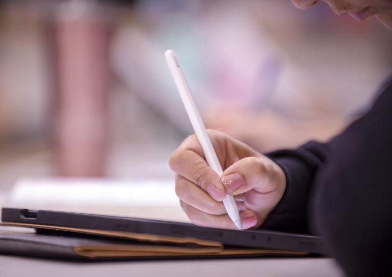 student using tablet in classroom