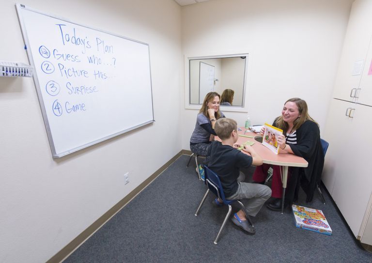 child works with Samantha Sheppard at the Scottish Rite Childhood Language Disorders Center.