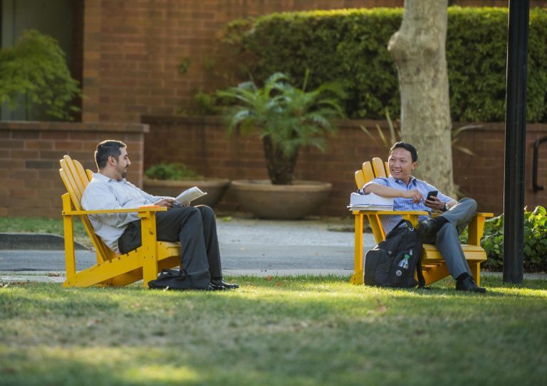 students sitting in lawn chairs