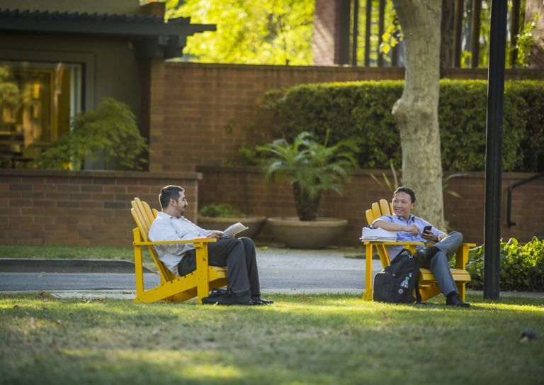 students sitting in lawn chairs