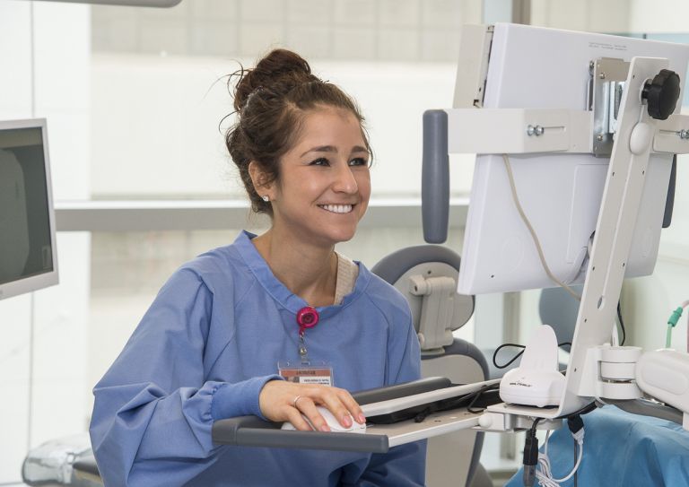 medical assistant entering records on computer