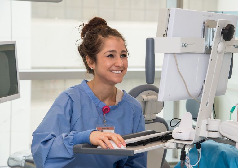 medical assistant entering records on computer