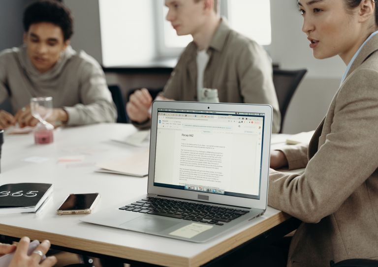 laptop sitting on table in meeting