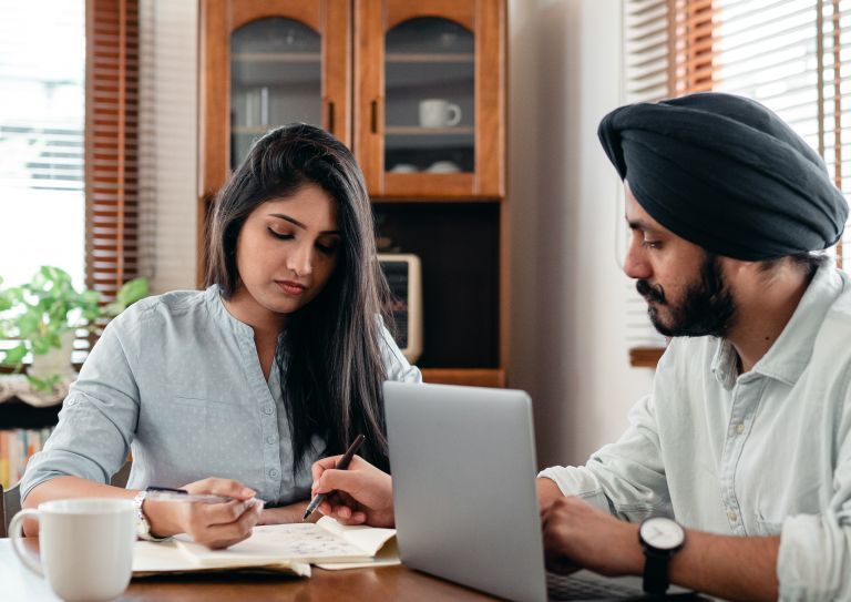 man and woman sitting at table reviewing papers