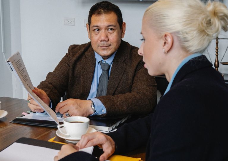 co-workers sitting at table reviewing documents