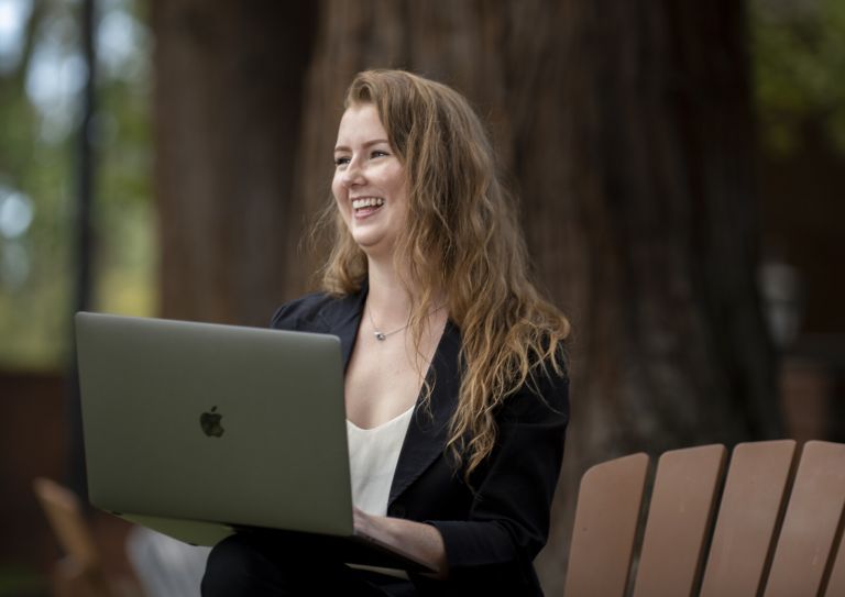 woman using laptop and smiling