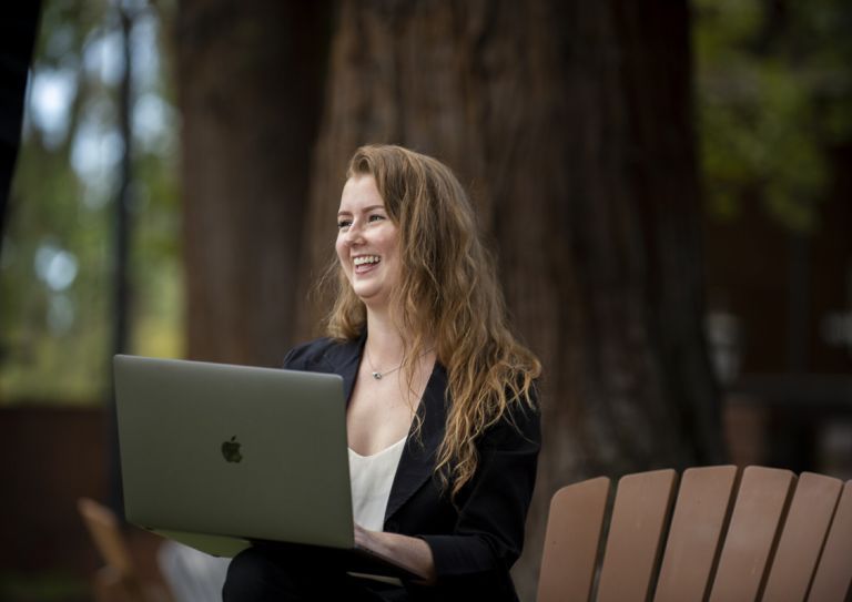 woman using laptop and smiling