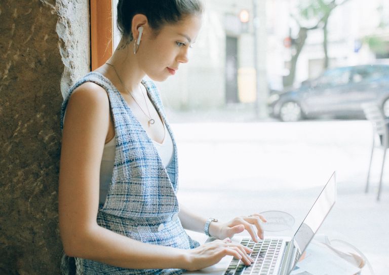 woman using laptop outdoors