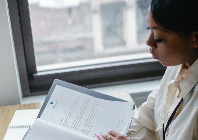 Woman looking at paperwork at desk
