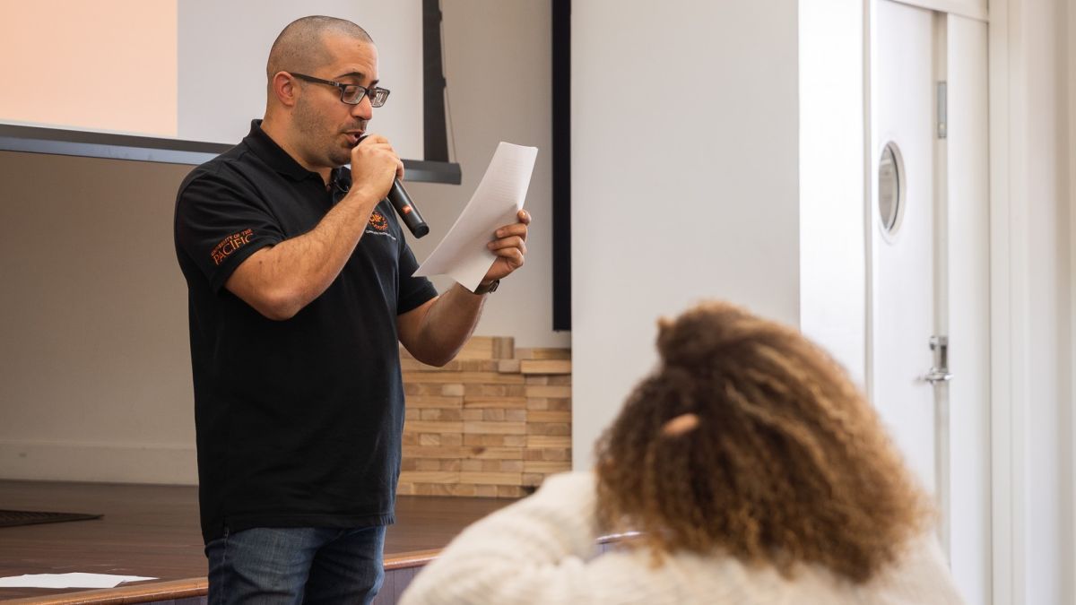 a student reads a speech during an event for MLK day