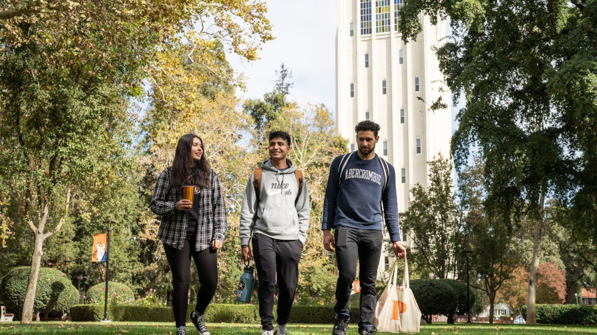 students walk across campus 