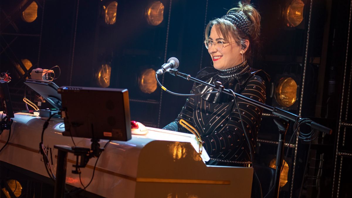 Katie Coleman sits at a keyboard during a musical performance