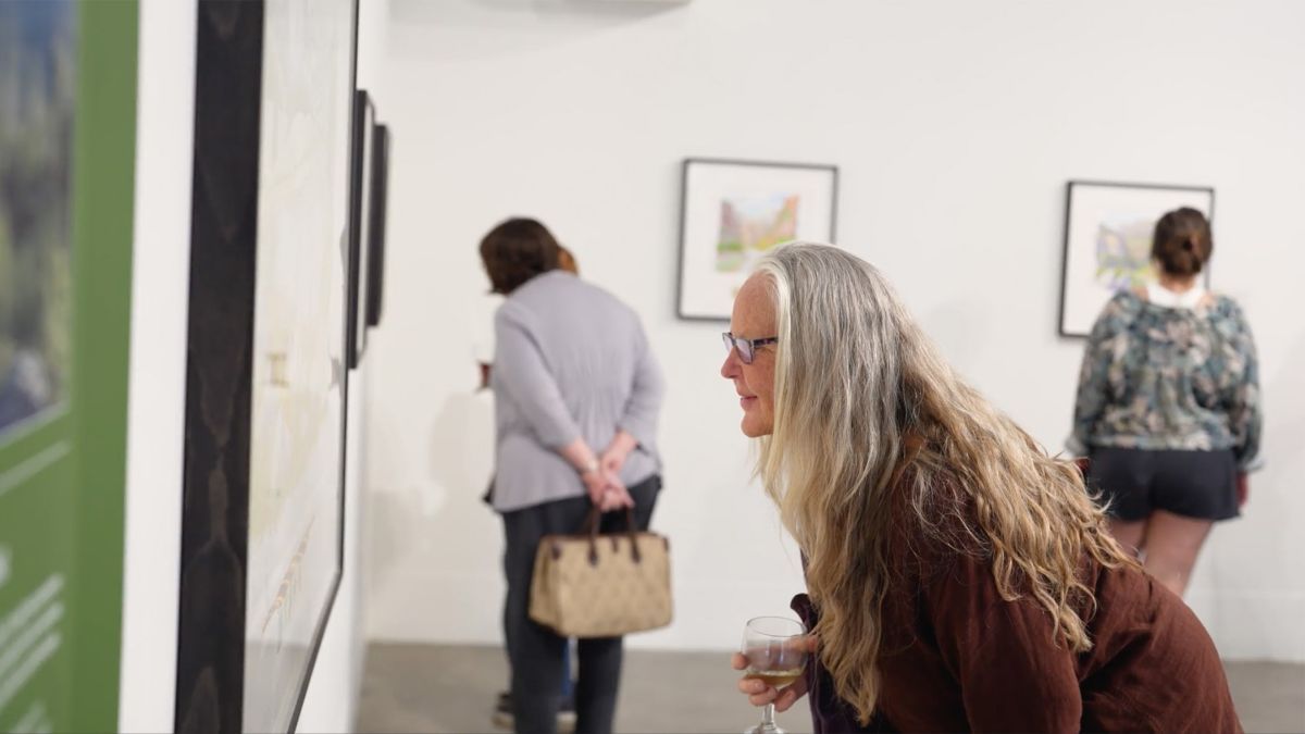 A woman looks at a watercolor painting at an exhibit inside University of the Pacific's Reynolds Gallery.