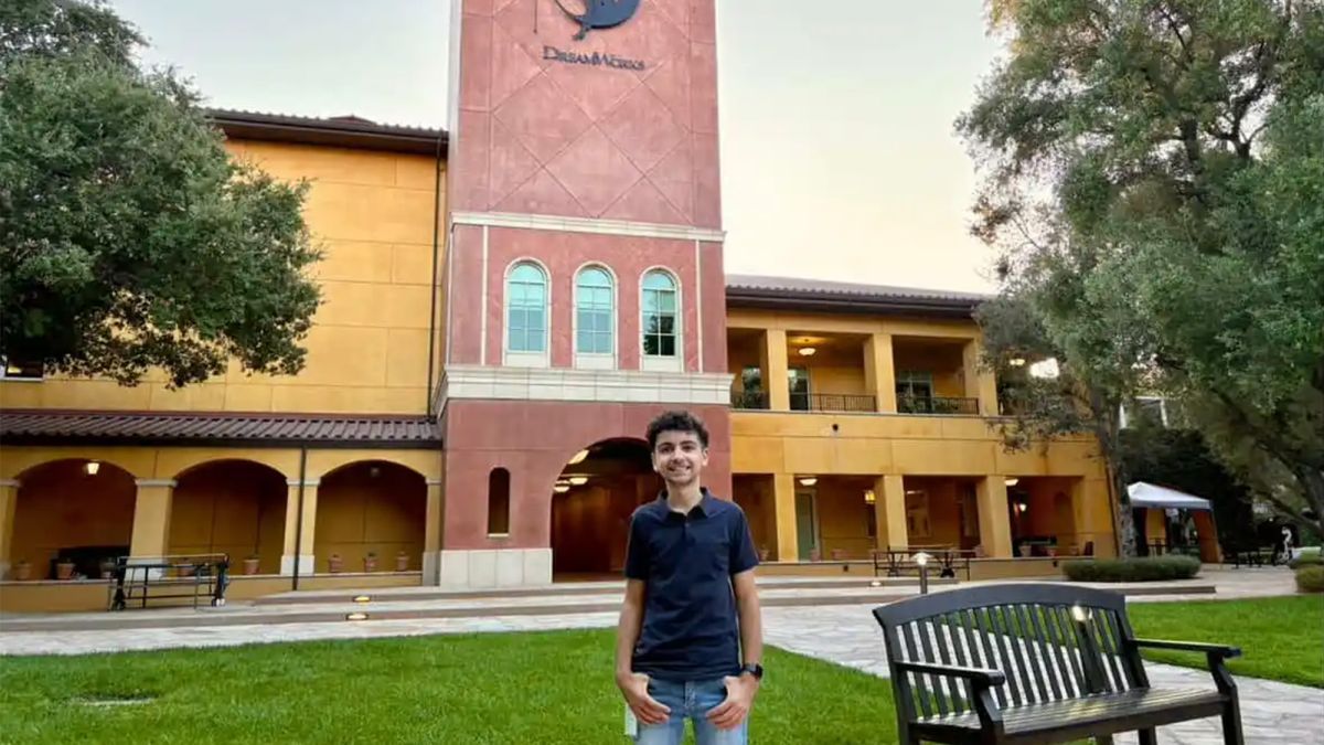 Student Ethan Fontes stands in front of a building that has a "DreamWorks" sign on it.