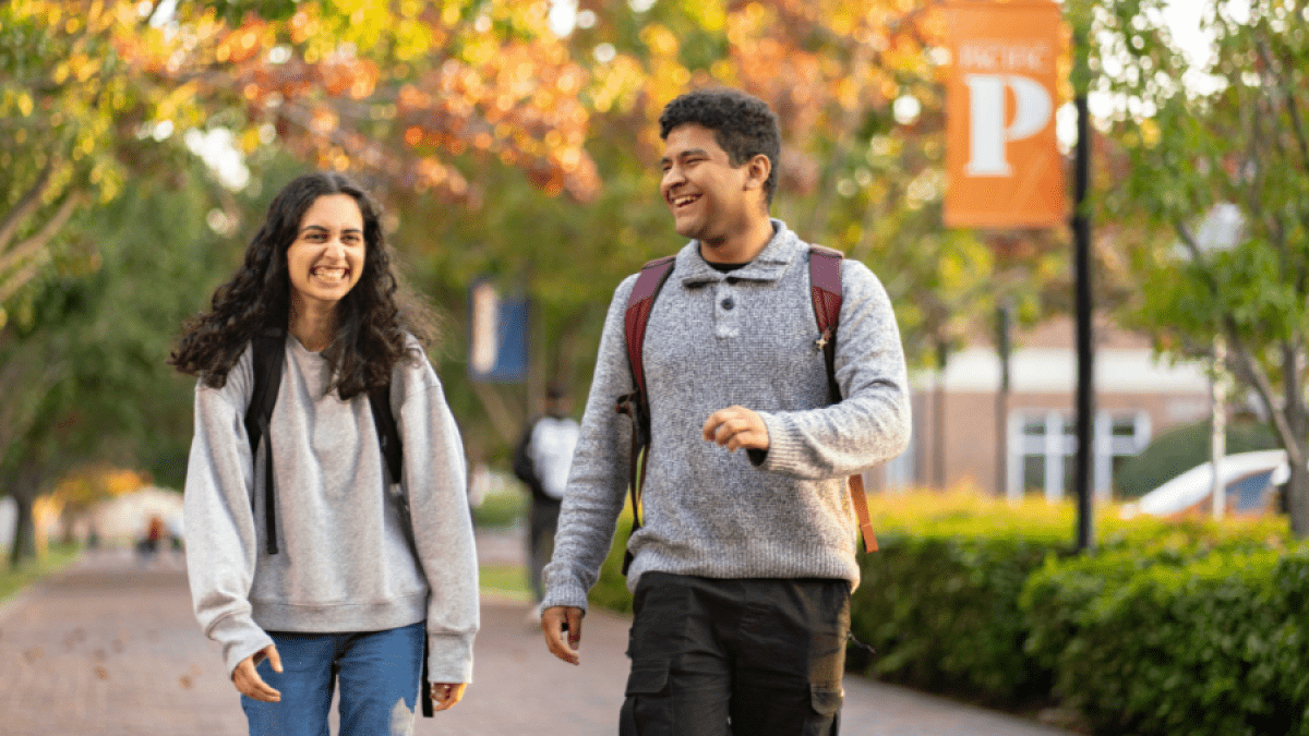 Two students walking on campus