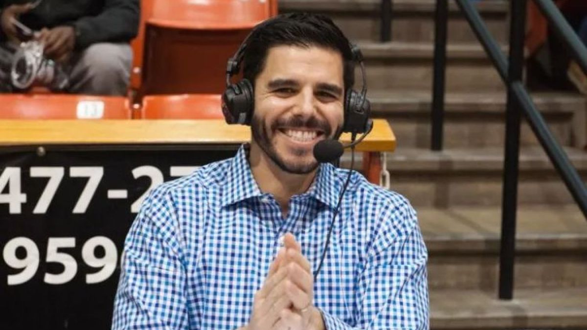 Zach Bayrouty sits with a headset on 