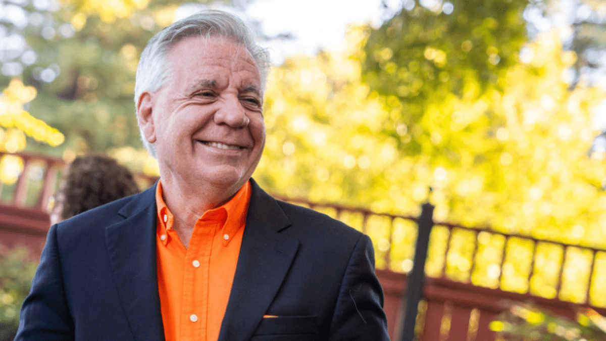 President Callahan in an orange shirt outside 