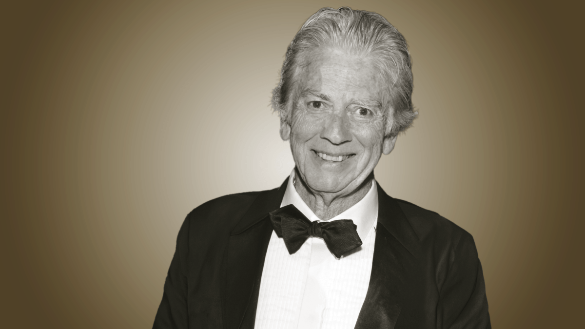 Photo of Bob Lee smiling, in a black and white suit.