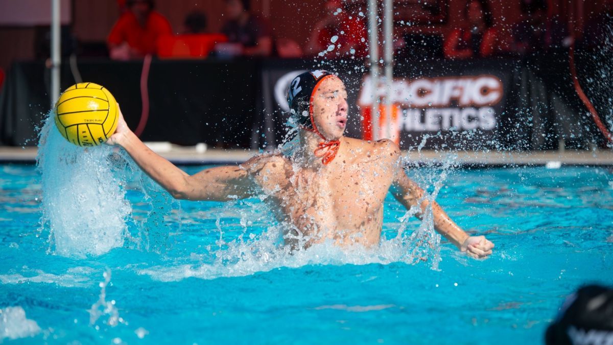 A waterpolo athlete throwing a ball in a pool