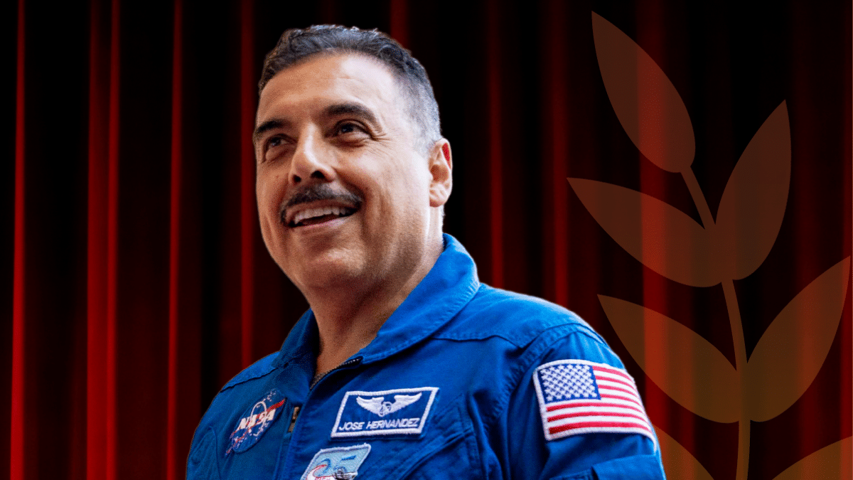 Jose smiles in a blue NASA uniform