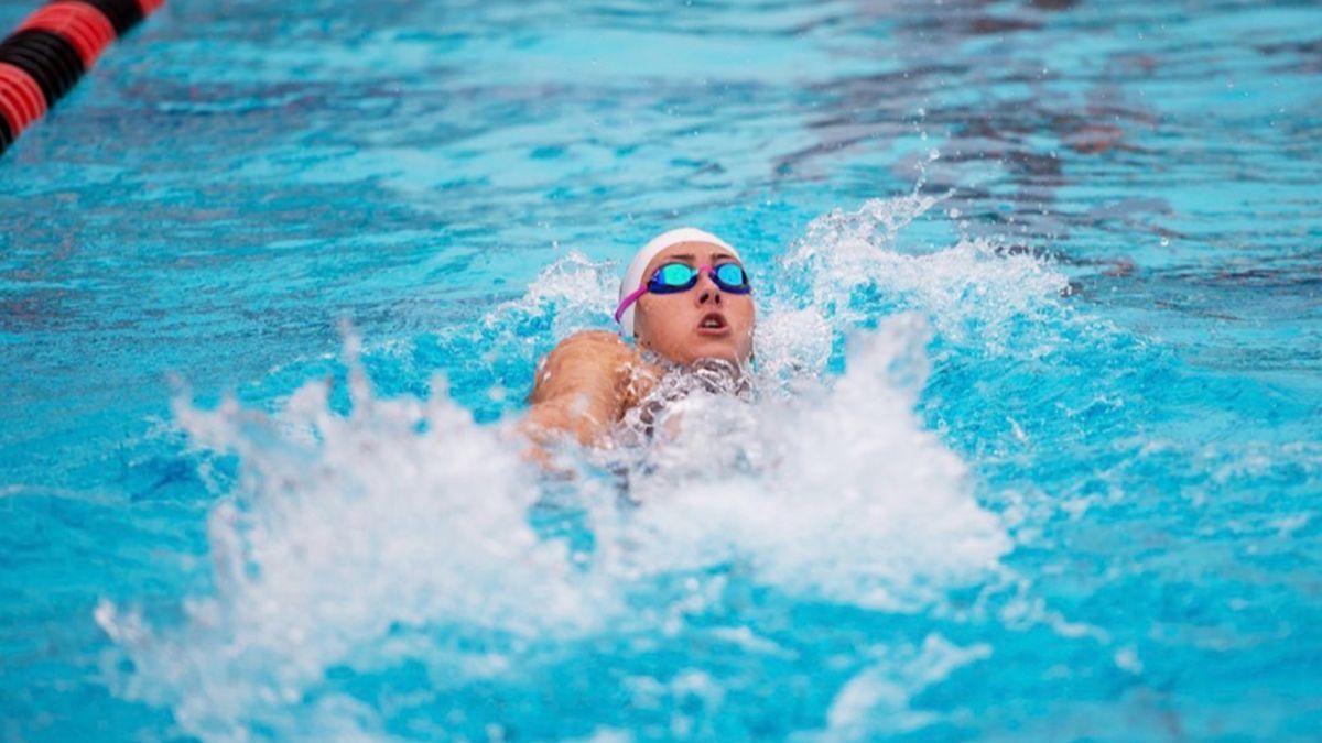 Macy Coad swims in the water 