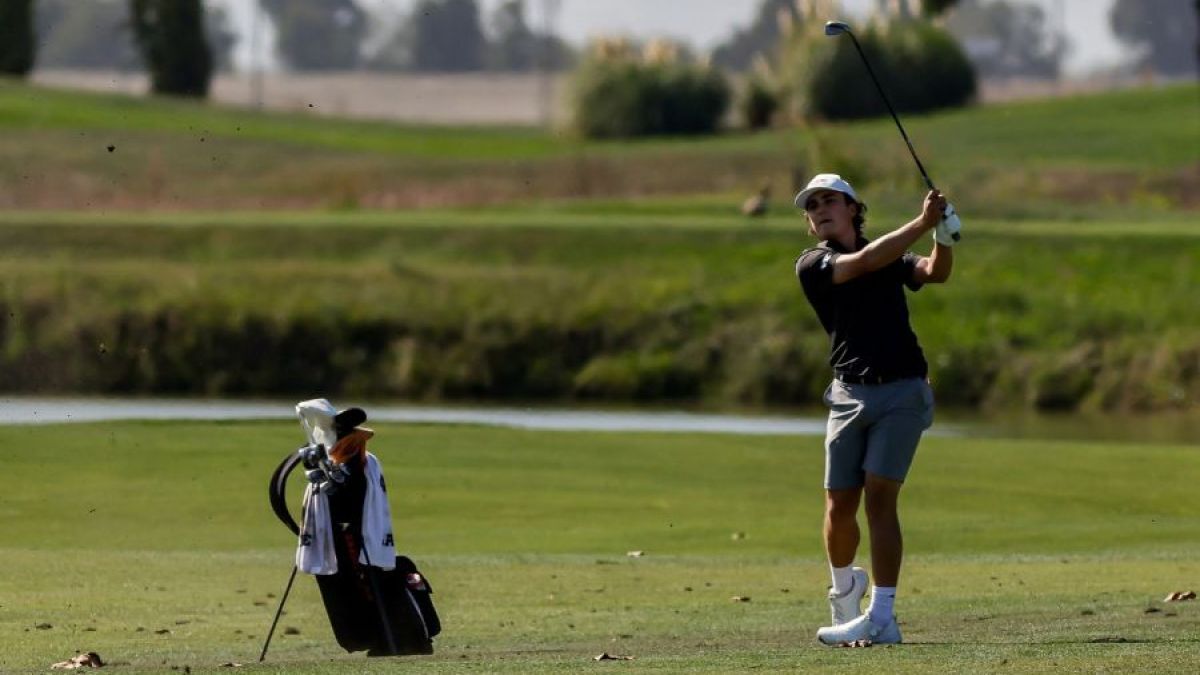 Bouchard swinging a gold club on a green course 