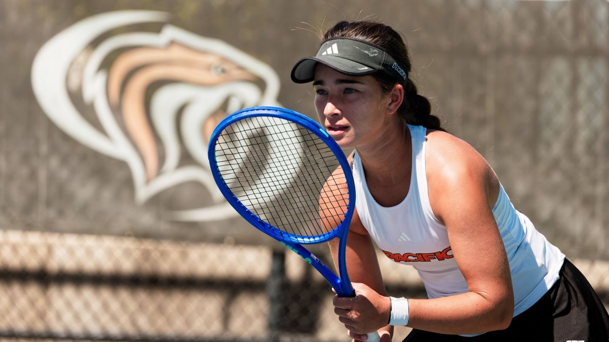 Indiya McLeod ’27 holds a tennis racket and prepares to hit the ball