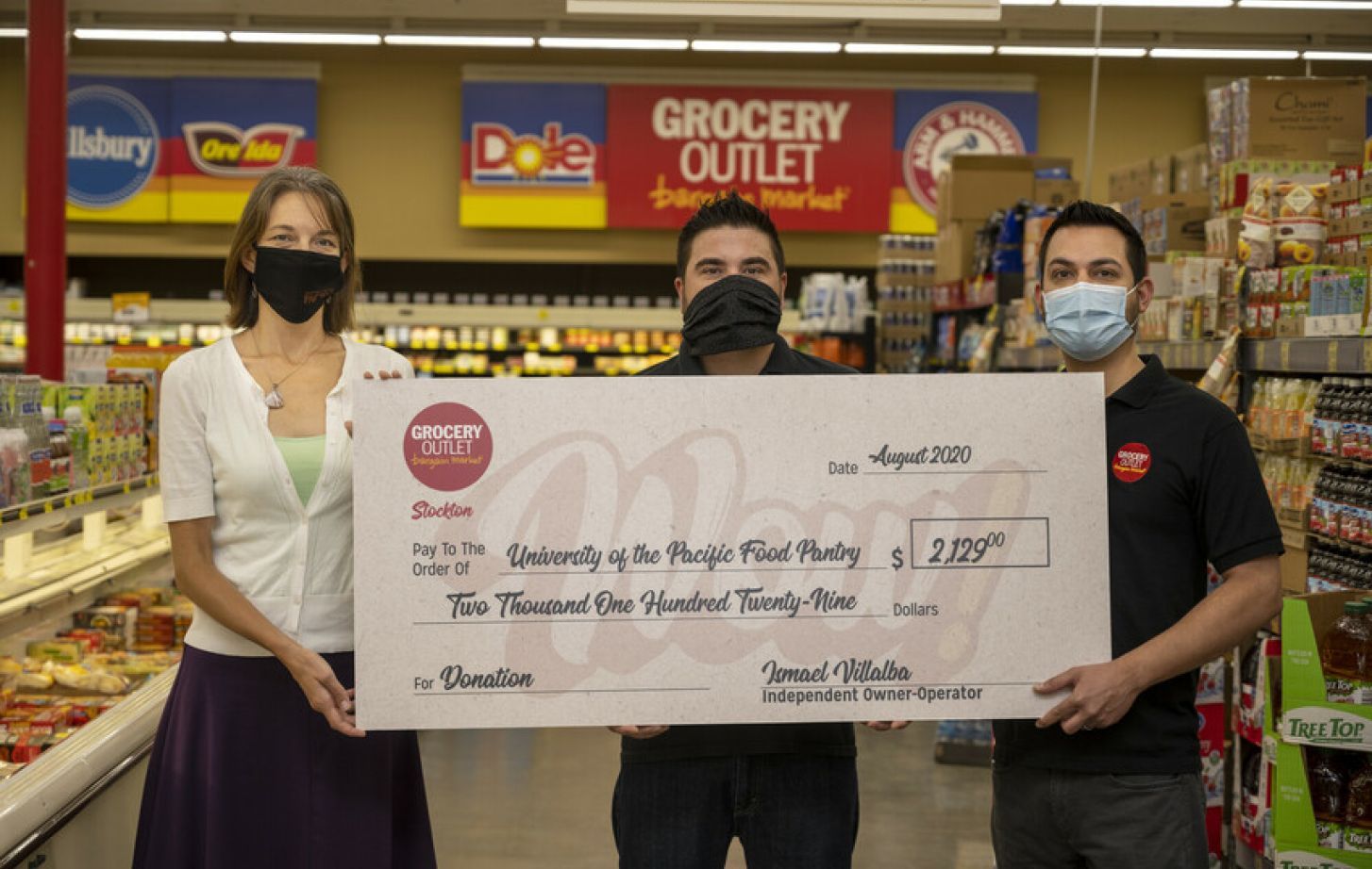 Jessica Bilecki of Pacific's food pantry with Ismael Villalba and Jesus Valenzuela, co-owners of the Grocery Outlet on North Wilson Way in Stockton.