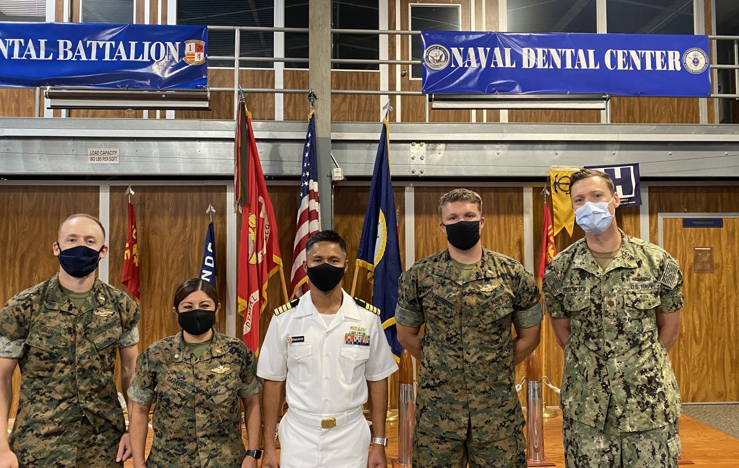 Left to Right: Lieutenant Adam Gluskin ’17, Commander Sherry Caraveo ’04, Captain Jerome Ragadio ’03, Lieutenant Michael Lawrence ’16 and Lieutenant Commander Eric Frederiksen ’11. (Not pictured: Lieutenant Commander Michael DeFazio ’13)
