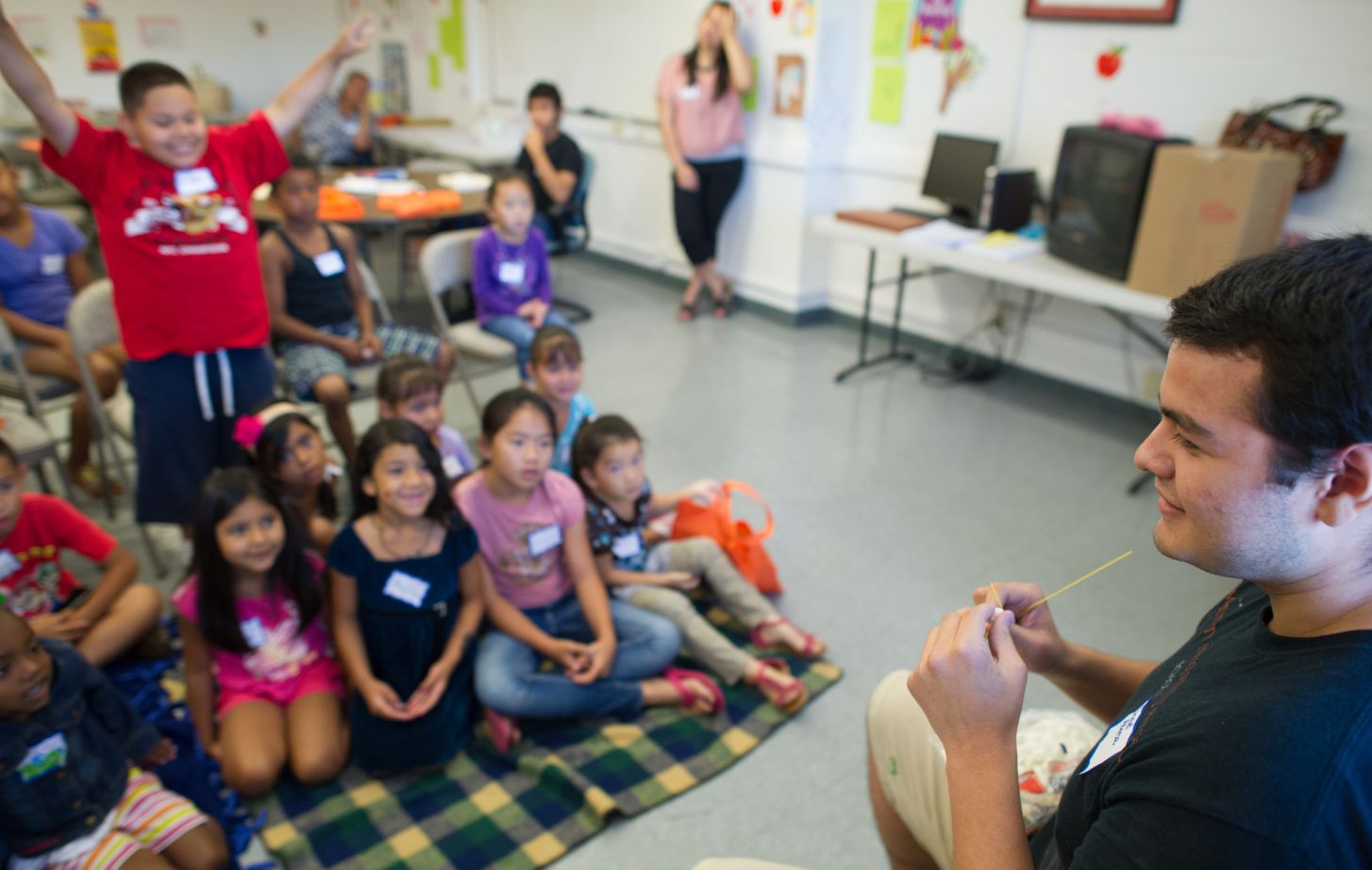 Student reading to kids