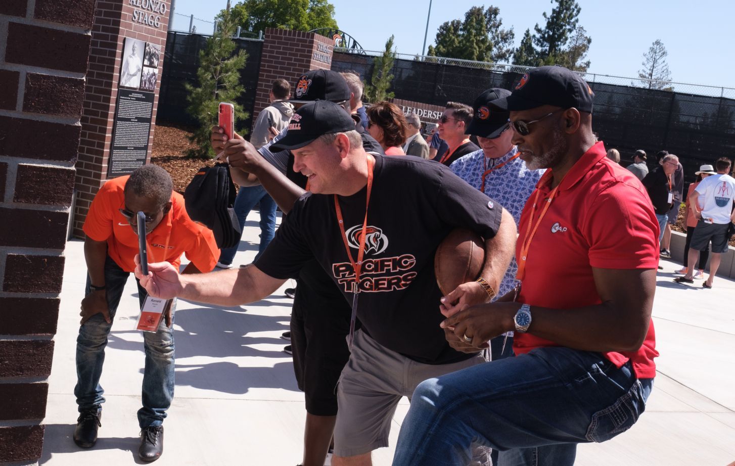 former football players looking at new football plaza