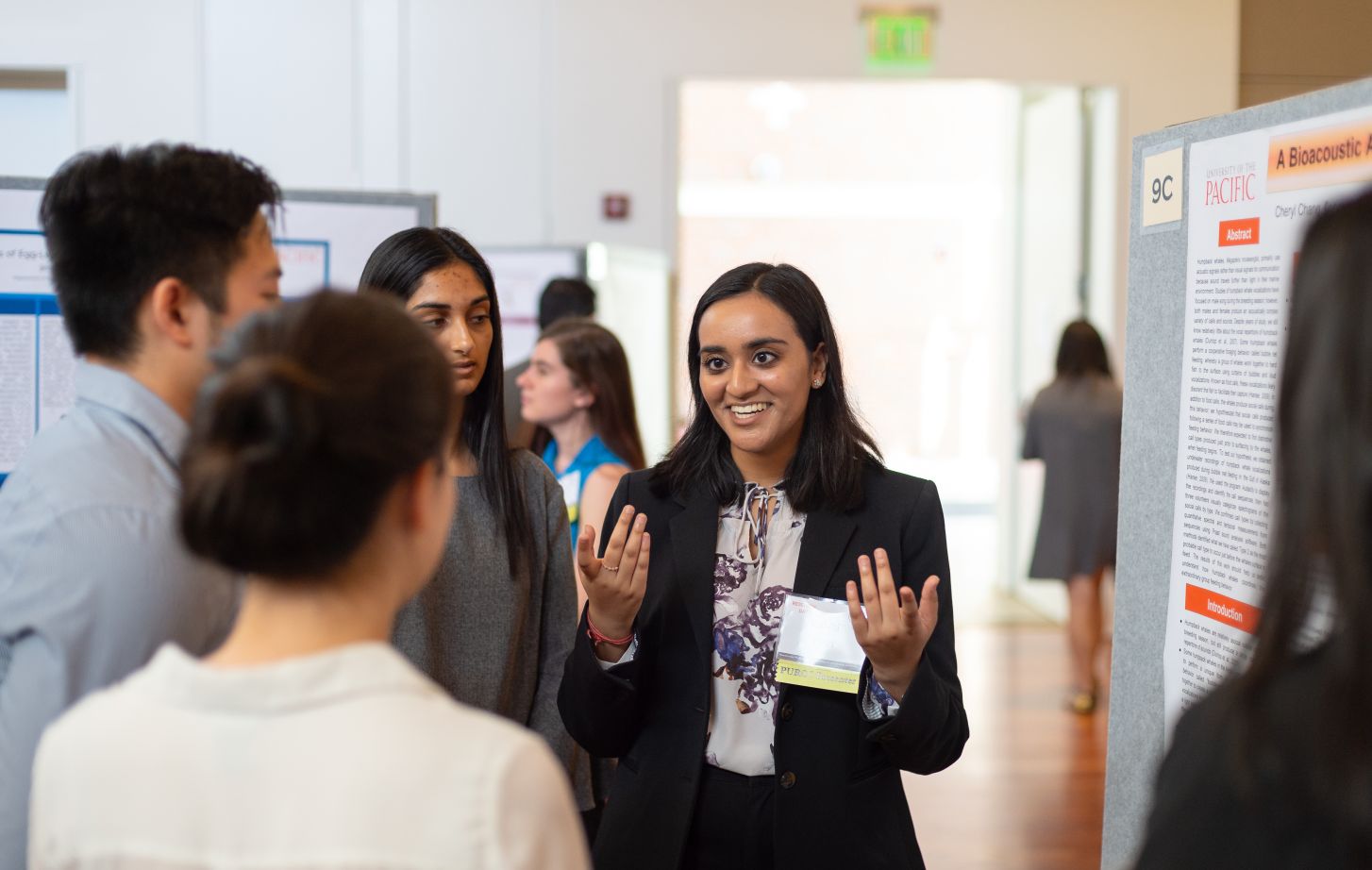 A student presents her research to other students