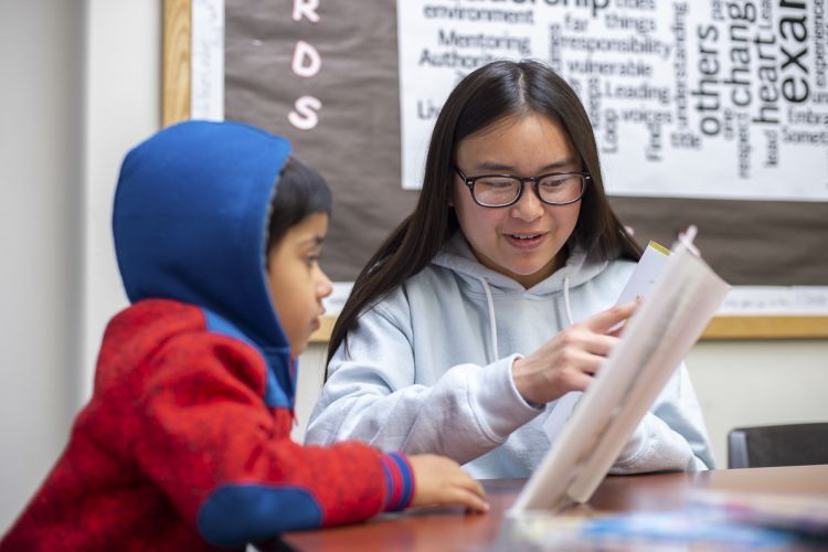 Pacific student reads to K-12 student