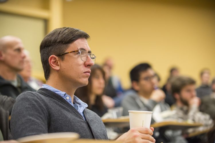 Students sit in a lecture hall 