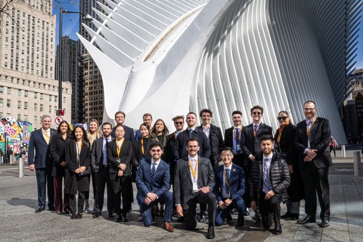 students pose for a picture on Wall Street