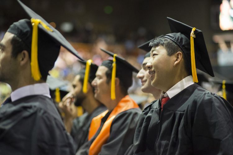 graduates attend a commencement ceremony