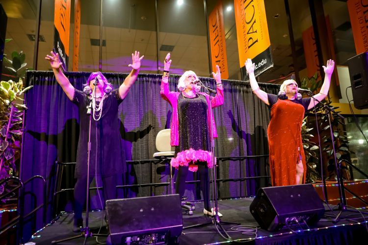 Three men sing and perform in drag