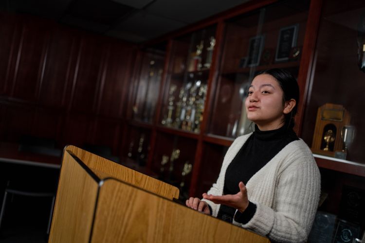 a student stands at a podium