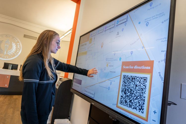 a student uses a new interactive campus map