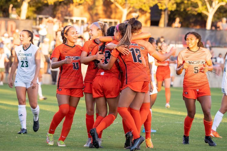 soccer team celebrates on the field 