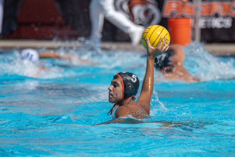 Cooper Gaderson prepares to throw a ball while playing water polo