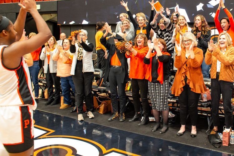 women cheering on women's basketball team