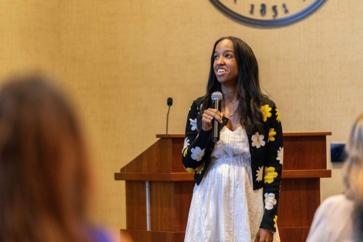 a student speaks in front of a podium