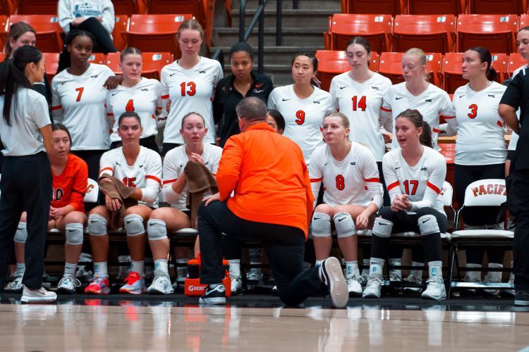 volleyball team gathers around coach