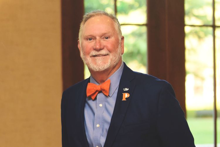 A portrait of a man in a suit and bowtie